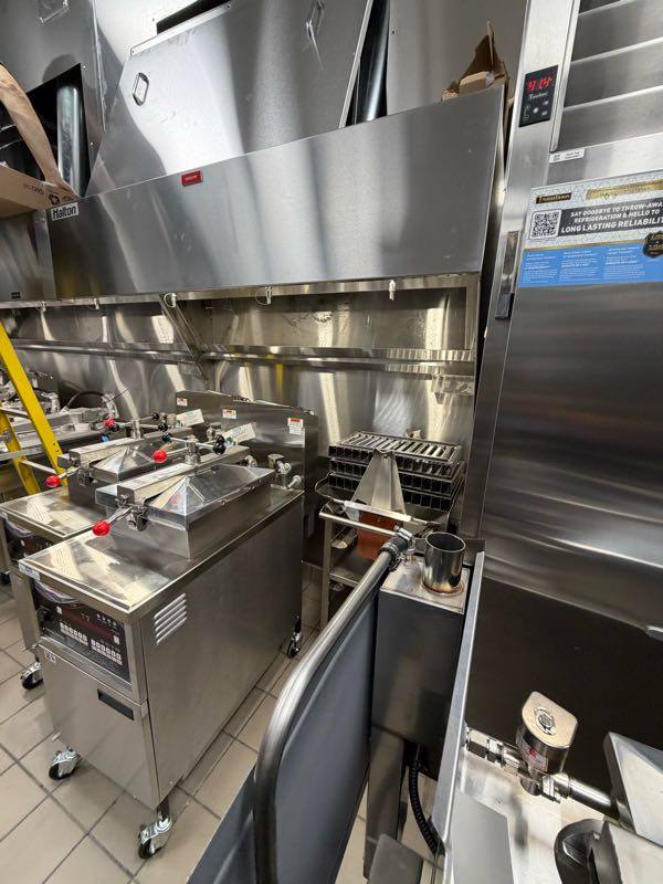 Commercial kitchen exhaust hood over a cooking line